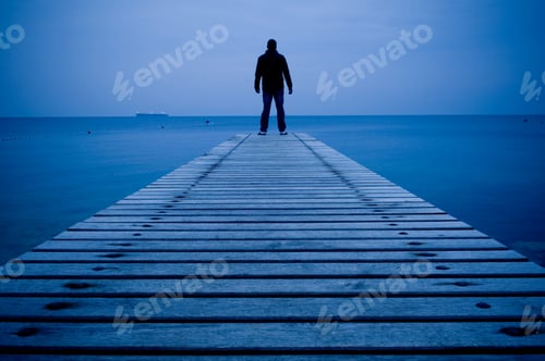 Preview: Man standing on a wooden pier
