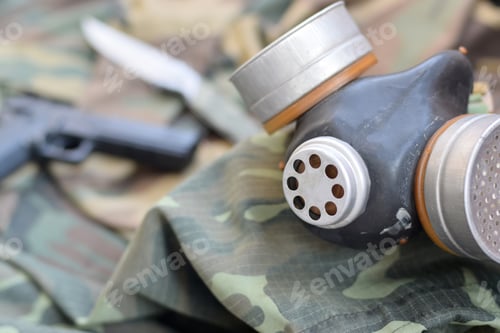 Preview: Stalker soldiers soviet gas mask lies with handgun and knife on green khaki camouflage jackets