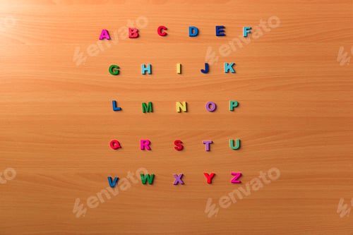 Preview: Colored alphabet letters on a wooden background