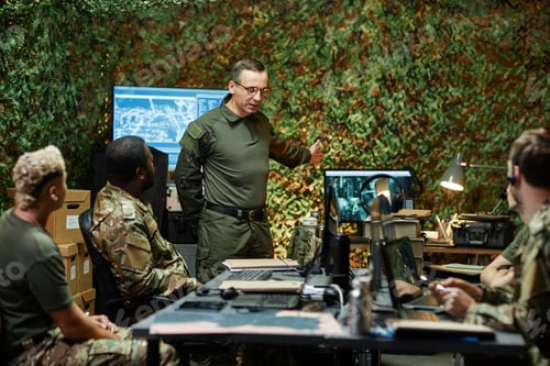 Preview: Confident man in uniform pointing at computer screen and explaining something