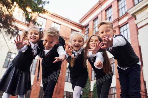 Preview: Group of kids in school uniform that is outdoors together near education building