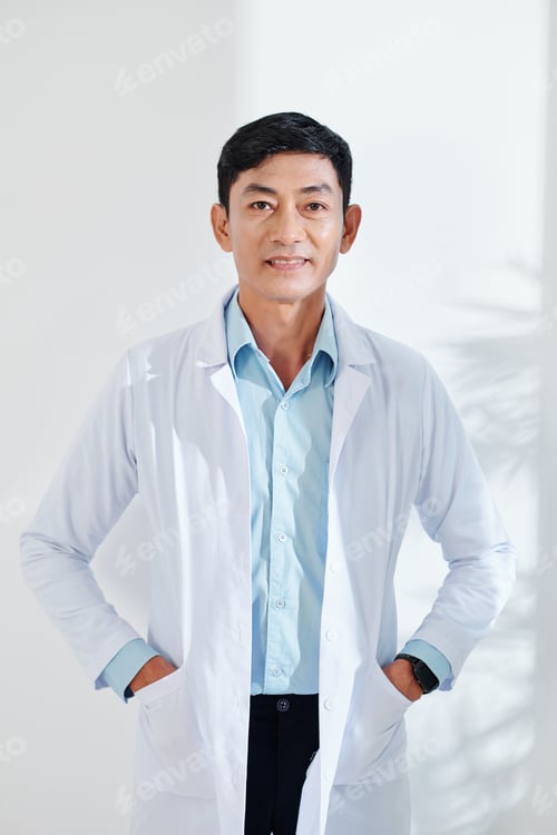 Preview: Smiling mature Asian general practitioner