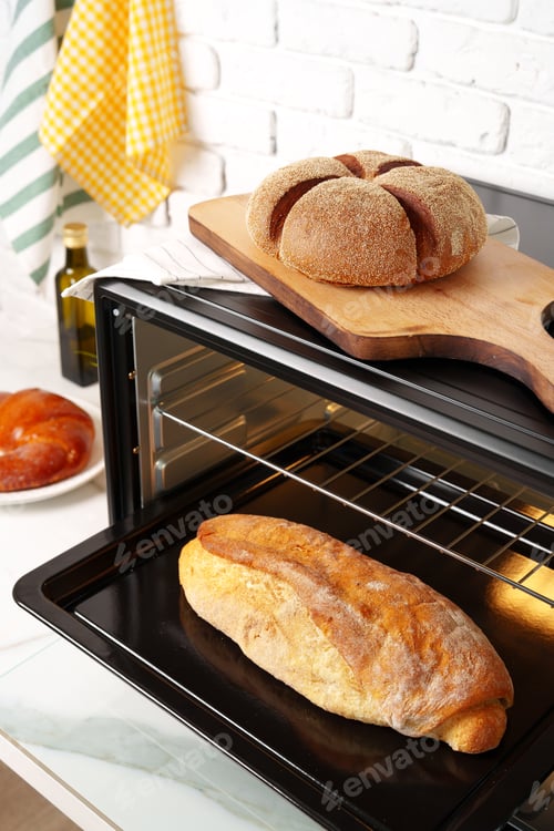 Preview: Freshly baked bread in mini oven in the kitchen