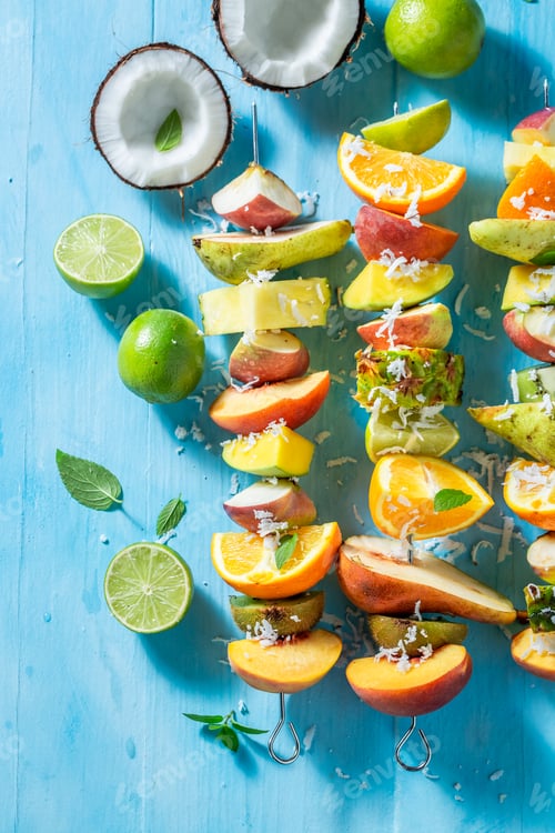 Preview: Colorful Fruit Kebabs with Coconut Flakes on Blue