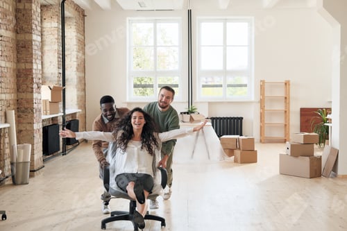 Preview: Excited colleagues having fun in empty office