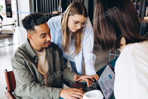 Preview: Diverse team of software developers collaborating on user interface design
