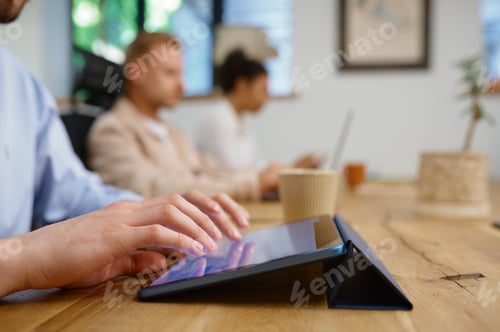 Preview: Closeup hands of male office worker using mobile tablet