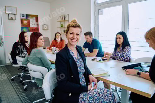 Preview: Diverse Business Team Discussing Projects in a Modern Glass Office.