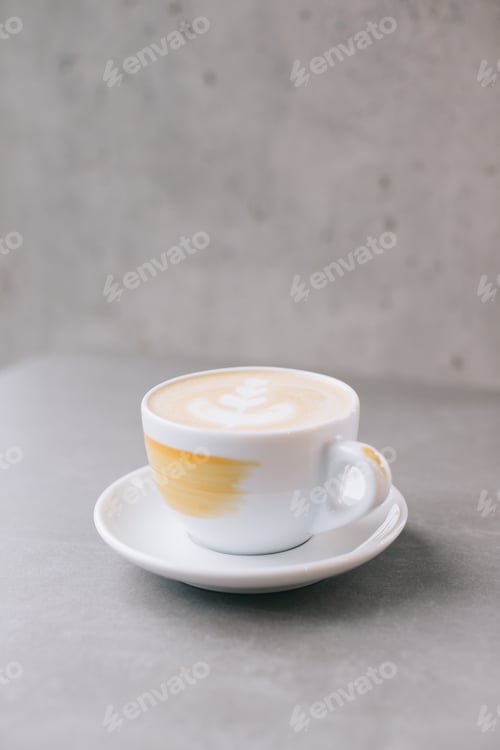 Preview: Close-up of a cup of latte or cocoa on a gray stone background.