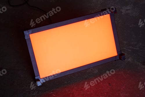 Preview: lighting LED panel stands on the floor and shines with orange light