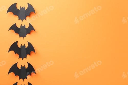 Preview: Halloween decor. Black paper bats on orange background, flat lay. Space for text
