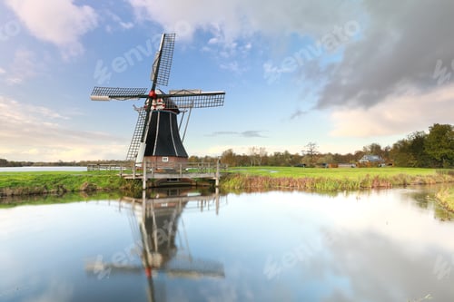 Preview: Dutch windmill by small lake