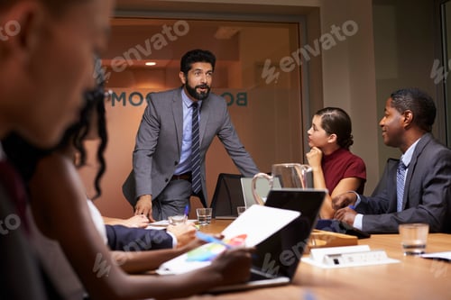 Preview: Businessman addressing team at a boardroom meeting, close up
