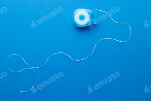 Preview: Image of dental string on blue surface