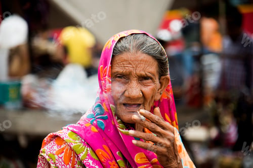 Preview: Old age woman smoking Indian handmade cigarette.
