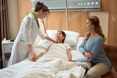 Preview: Woman doctor examines a girl lying on a special bed