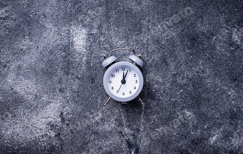 Preview: Grey vintage alarm clock on concrete table