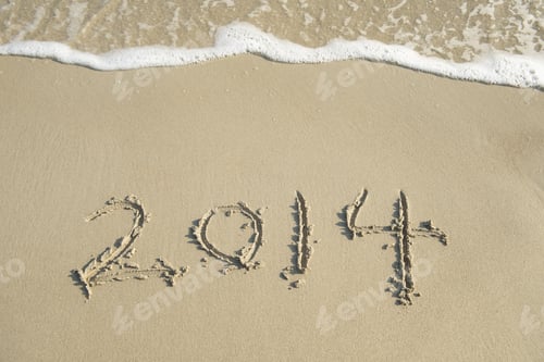 Preview: New Year 2014 Is Coming Concept-New Year 2014 Written In Sand On The Beach