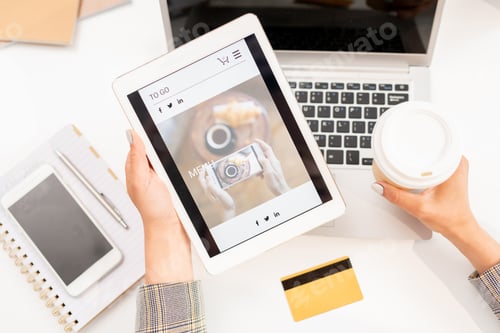 Preview: View of tablet with screensaver of online shop held by businesswoman