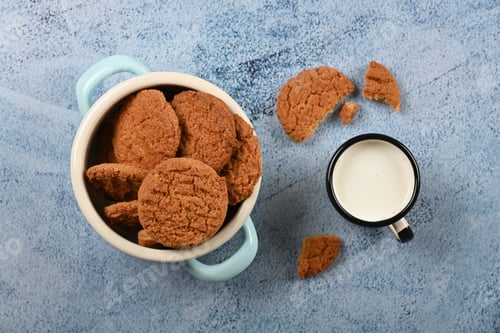 Preview: Oatmeal cookies and pannikin of milk on blue table