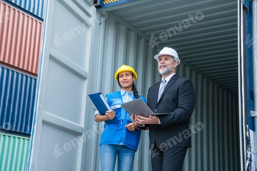Preview: Container yard manager with safety hat talking to foreman about the goods inside the warehouse.