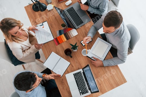 Preview: Top view. Group of business people that working on the project in the office