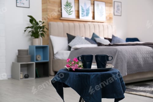 Preview: Blue cups and flowers on table in bedroom