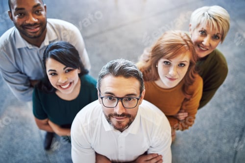 Preview: High angle portrait of a team of colleagues standing together in a modern office