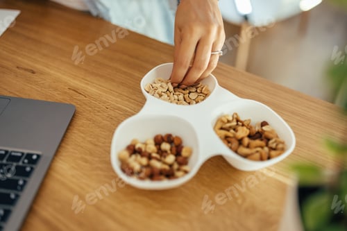 Preview: Eating healthy snacks while working, close-up.