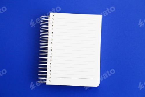 Preview: Top view of blank note paper on blue background