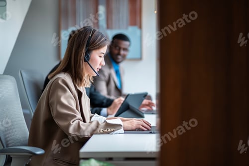 Preview: Asian female call center work hard Currently serving customer through communication channel company