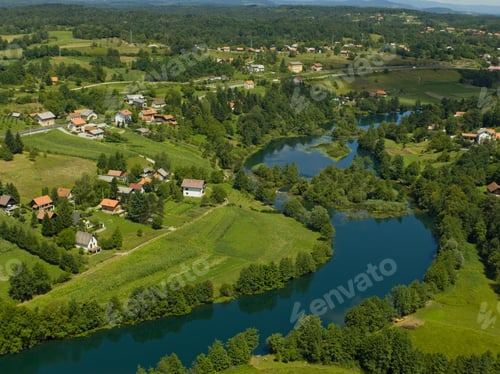 Preview: Drone view of The Mreznica surrounded by greenery on a sunny day in Karlovac County, Croatia