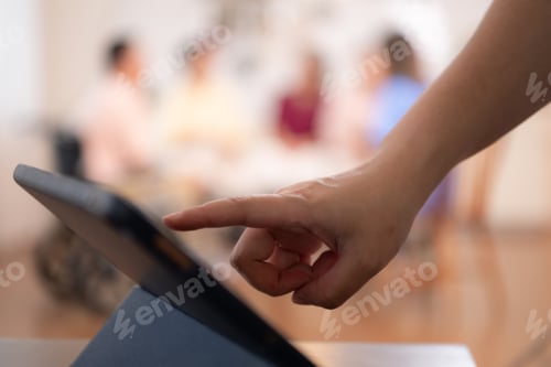 Preview: Close-up of female hand touching screen of digital tablet in office