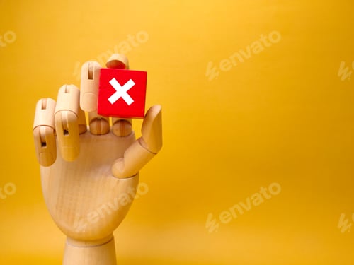 Preview: Wooden hand holding red cube with error sign.Concept of negative decision making or choice of vote w