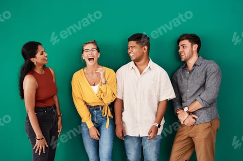Preview: Shot of a group of young designers standing together against a green background