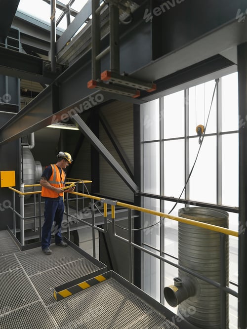 Worker operating machinery in factory