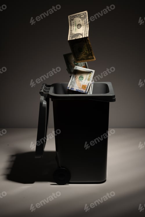 Preview: Flying dollar banknotes in the trash can