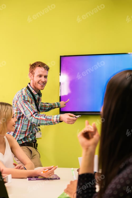 Preview: Teacher explaining the lesson to his students.