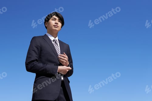 Preview: A Japanese male businessman with a blue sky background
