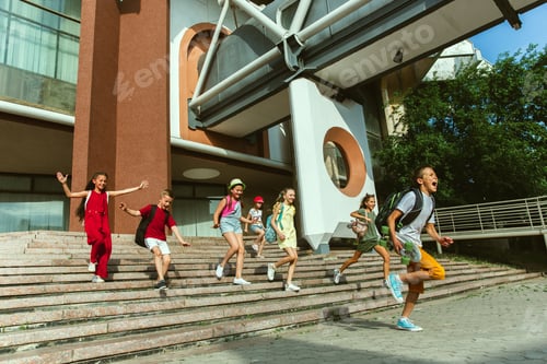 Preview: Happy kids playing at city's street in sunny summer's day