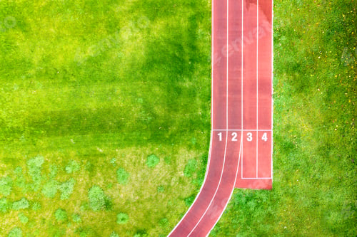 Preview: Aerial view of sports stadium with red running tracks with numbers on it and green grass