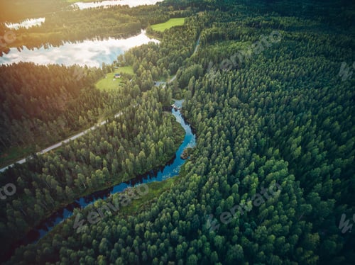 Preview: Aerial view road and river flowing through the green forest in Finland