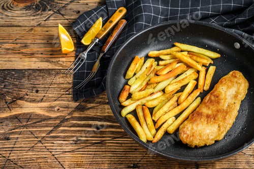 Preview: English Traditional Fish and chips dish in a pan. Wooden background. Top view. Copy space
