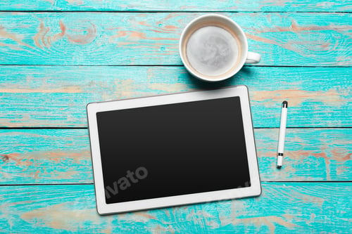 Preview: digital tablet and coffee cup on wooden table