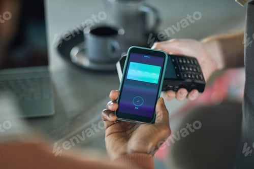 Preview: Man Paying with Smartphone in Cafe