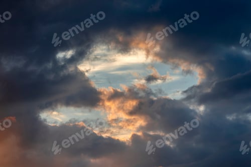 Preview: Dark stormy sky with moody clouds at the sunset