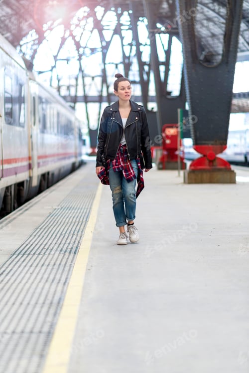 Preview: Stylish woman walking on railway station
