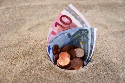 Preview: Euro bills and copper coins in the sands
