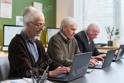 Preview: Senior Caucasian Men and Woman Practicing Typing Skills on Laptop Computers