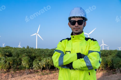 Preview: Engineer with smartphone at wind farm